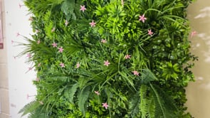 Artificial green wall panel with mixed 3d light-dark green foliage with scheffleras & pink flowers  100x100 cm