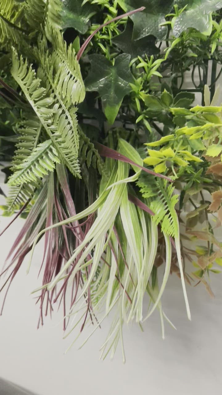 Artificial green wall panel with variegated green, red,  white & yellow foliage with ferns, palm heads, grasses & white flowers  100x100 cm