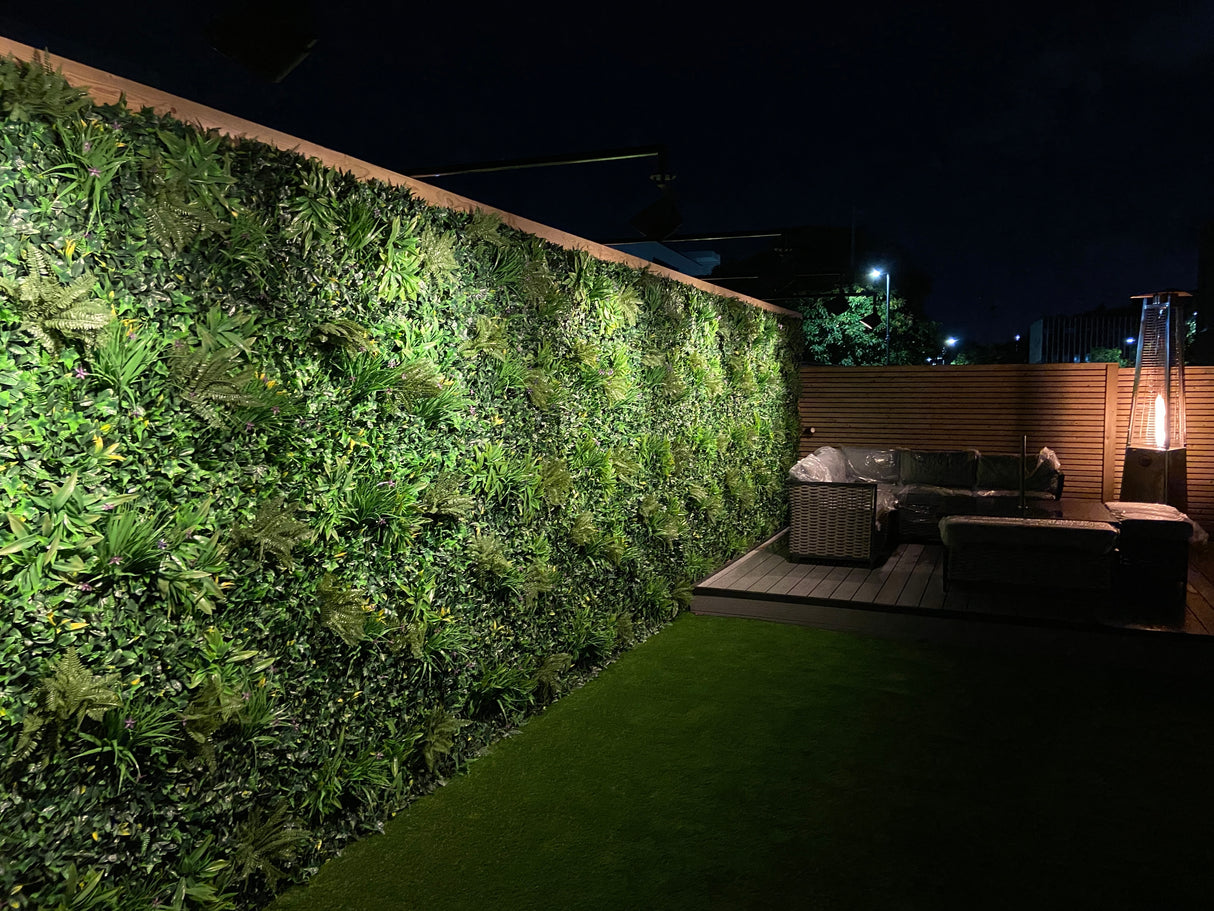 Artificial green wall panel with variegated greens of ivy, ferns, palm heads, grasses & yellow tipped privets  100x100 cm