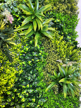 Artificial green wall panel varigated  green foliage  palms heads and white purple-pink flowering heads 100x100 cm