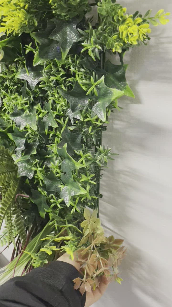 Artificial green wall panel with variegated green, red,  white & yellow foliage with ferns, palm heads, grasses & white flowers  100x100 cm
