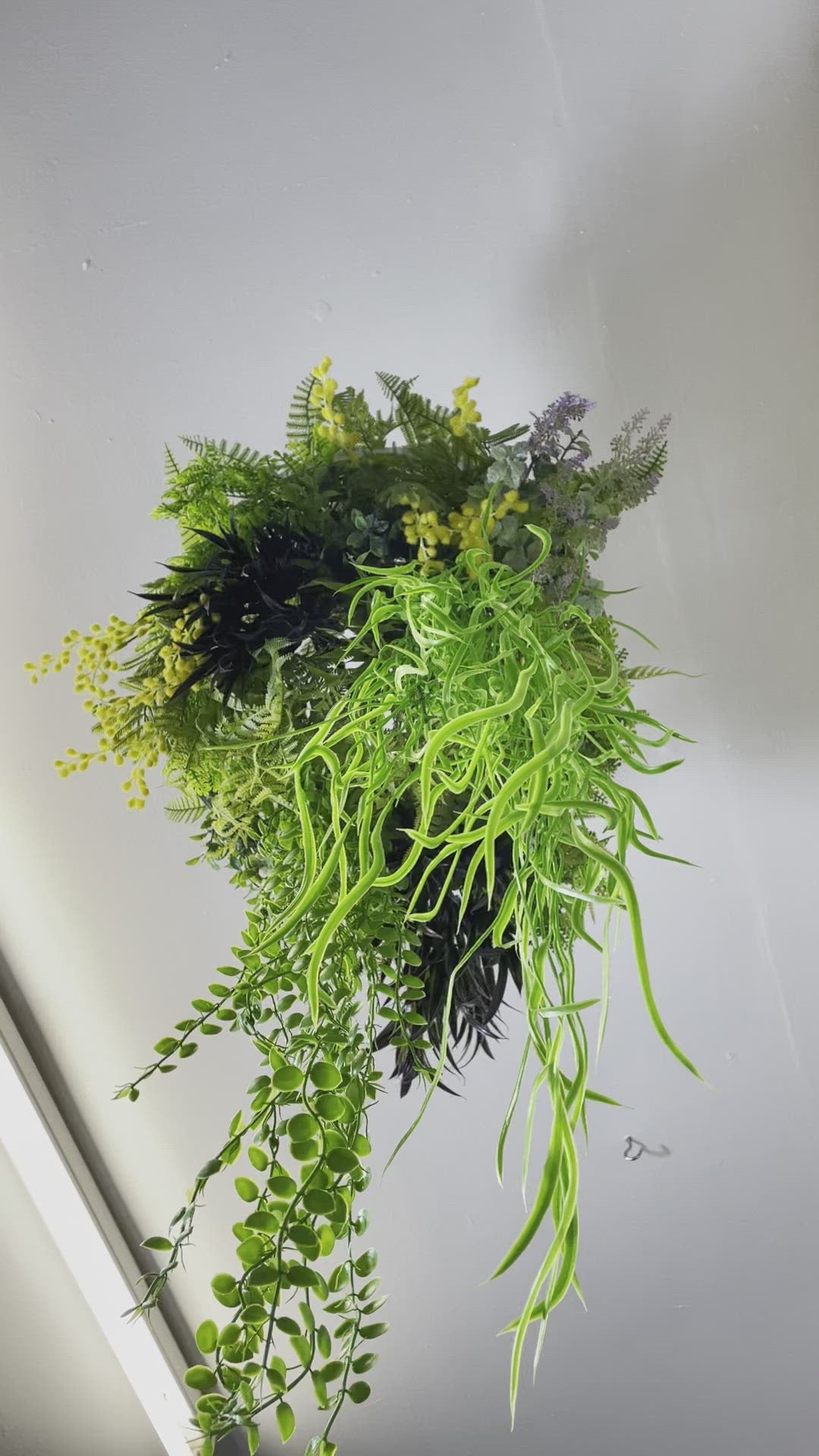 Hanging hoop with a mixture of artificial green plants with yellow flowers 40cm diameter