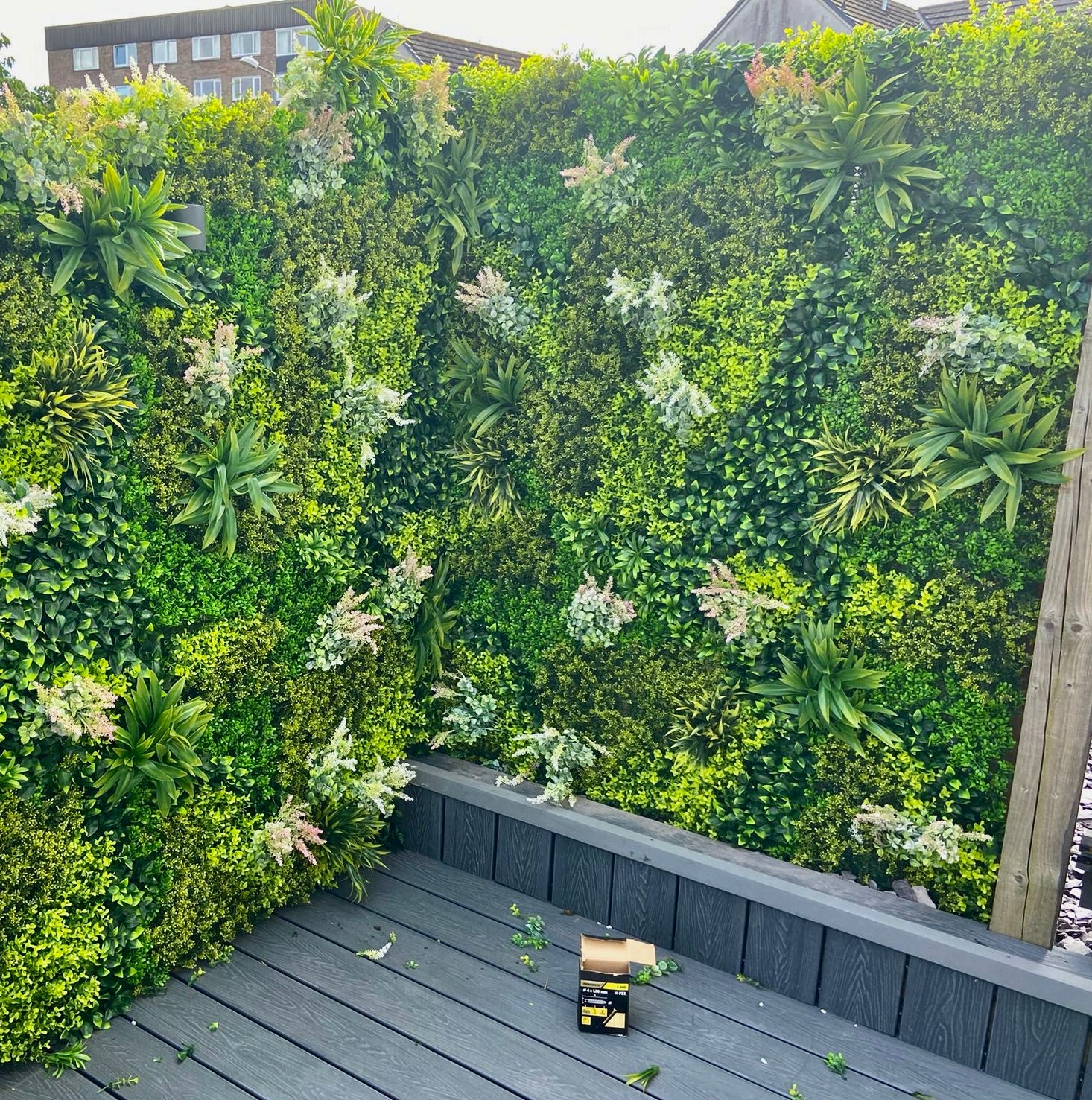 Artificial green wall panel varigated  green foliage  palms heads and white purple-pink flowering heads 100x100 cm