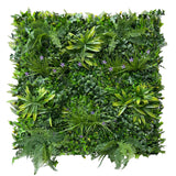 Artificial green wall panel with variegated greens of ivy, ferns, palm heads, grasses & small purple flowers  100x100 cm