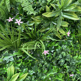 Artificial green wall panel with variegated greens of ivy, ferns, palm heads, grasses & small pink flowers 100x100 cm