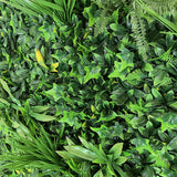 Artificial green wall panel with variegated greens of ivy, ferns, palm heads, grasses & yellow tipped privets  100x100 cm