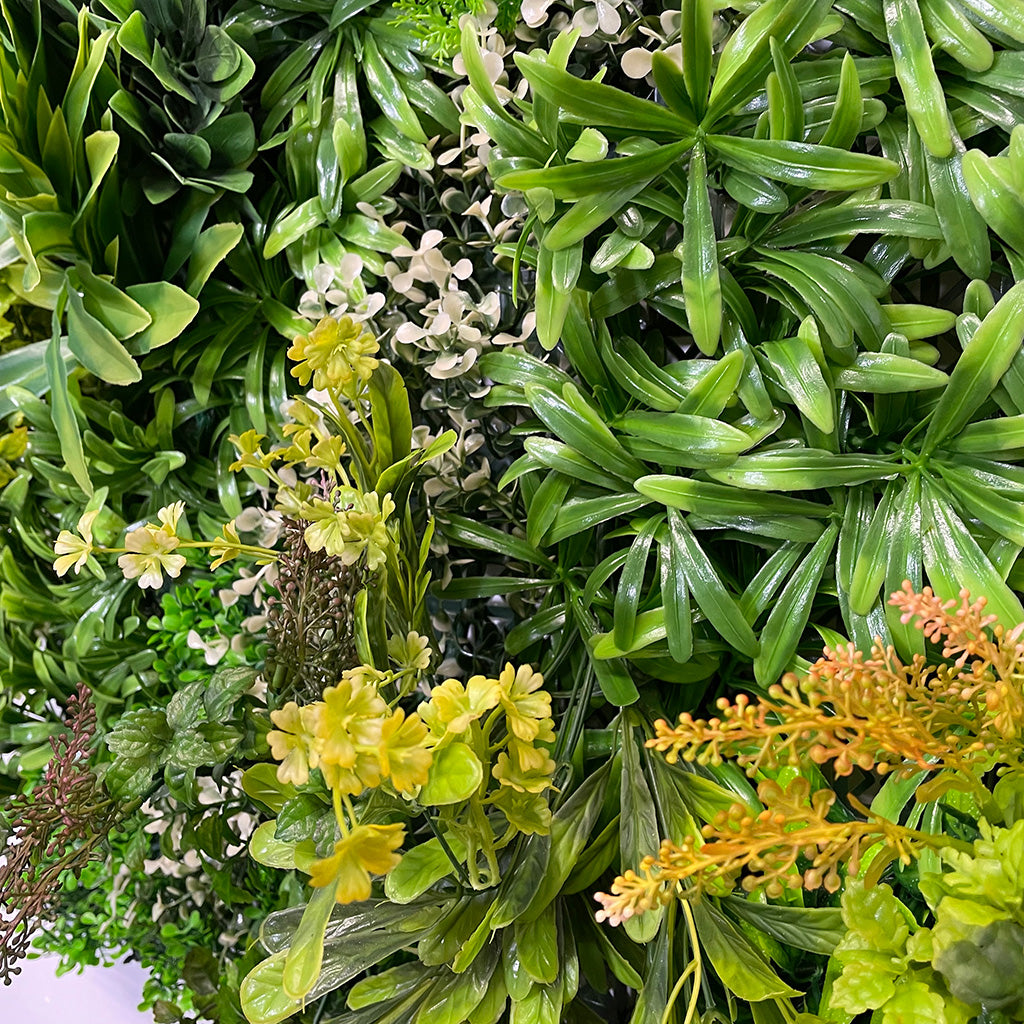 Artificial green wall panel varigated  green foliage  palms heads white flowers and orange flowering heads   100x100 cm
