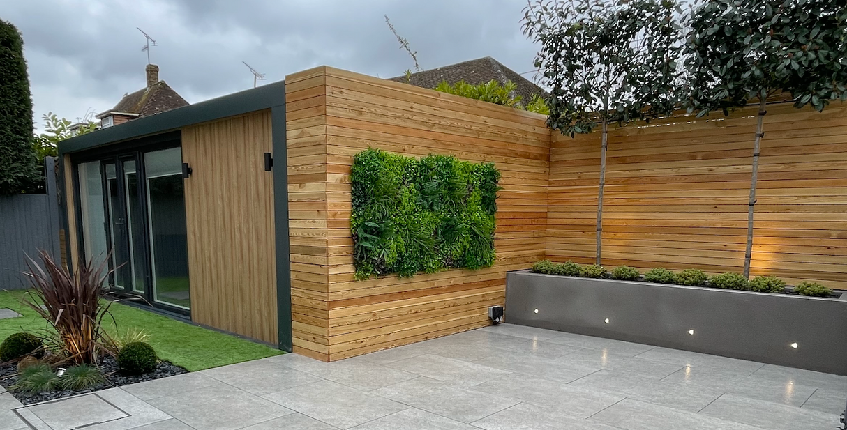 Artificial green wall panel with variegated mixed greens, palms, grasses, reds, white and yellow flowers  100x100 cm