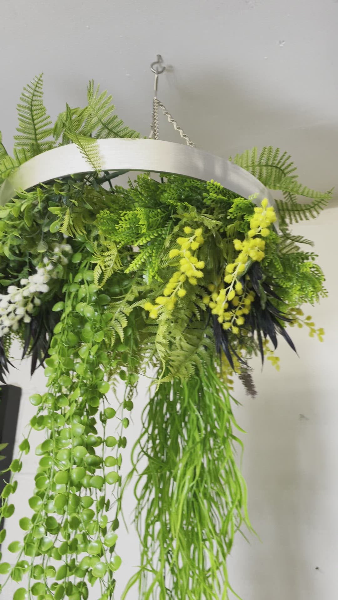 Hanging hoop with a mixture of artificial green plants with yellow flowers 40cm diameter