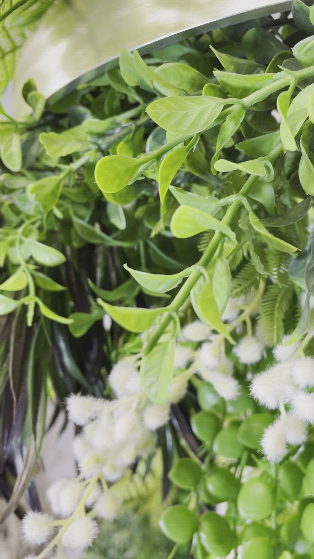 Hanging hoop with a mixture of artificial green plants with yellow flowers 40cm diameter