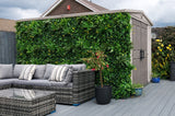 Artificial green wall panel with variegated greens of ivy, ferns, palm heads, grasses & small yellow flowers  100x100 cm