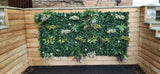 Artificial green wall panel with variegated green, red,  white & yellow foliage with ferns, palm heads, grasses & white flowers  100x100 cm