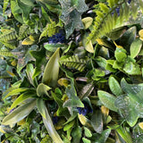 Artificial green wall panel with variegated greens of ivy, ferns, palm heads, grasses & blue-purple flowers  100x100 cm
