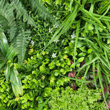 Artificial green wall panel with variegated mixed greens, palms, grasses, reds, white and yellow flowers  100x100 cm