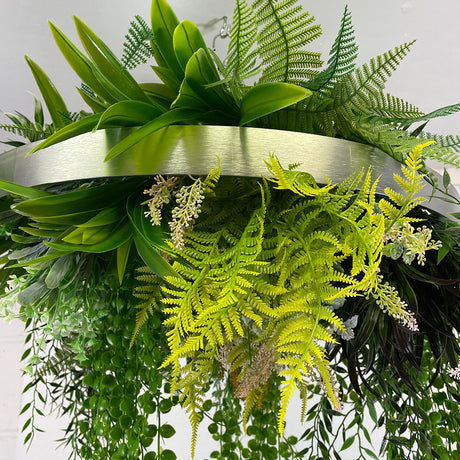 Hanging hoop with a mixture of artificial green plants with yellow flowers 60cm diameter